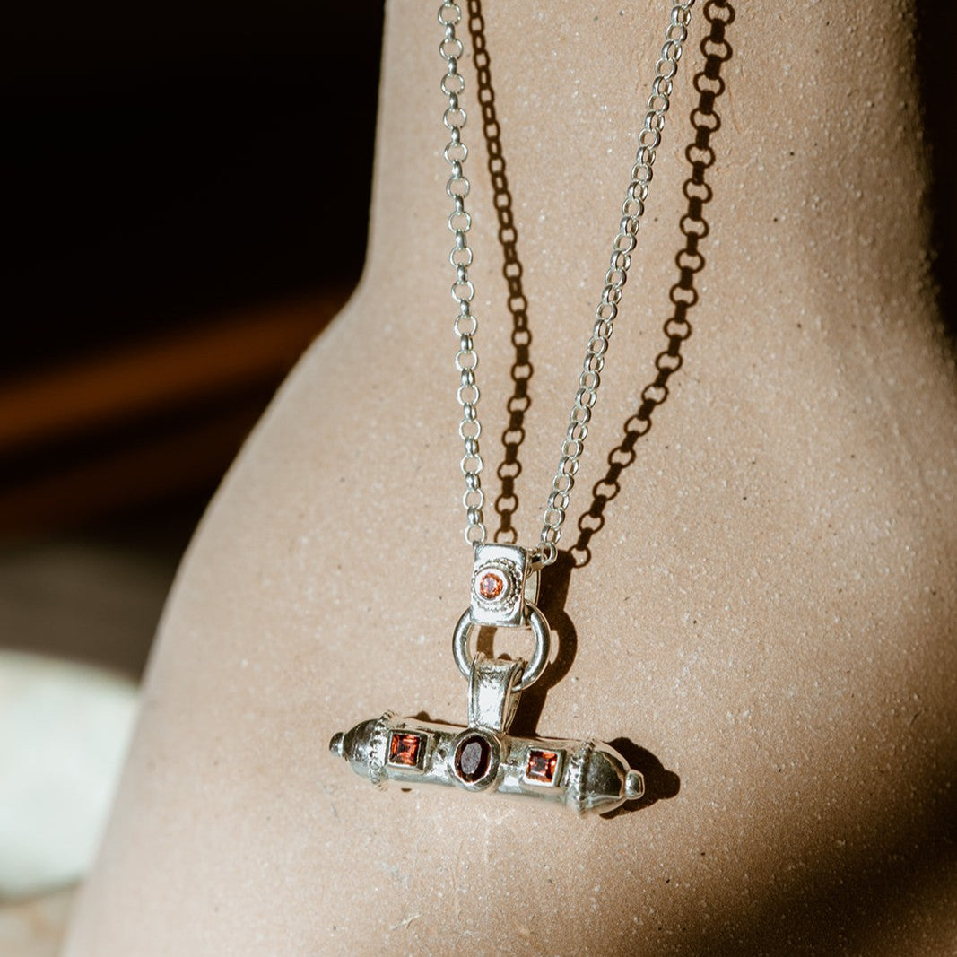 Small-batch Nivara Amulet Pendant showing artisanal texture and organic finish