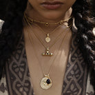 Long gold vermeil pendant inspired by Athena, goddess of courage and clarity worn with other layering amulets