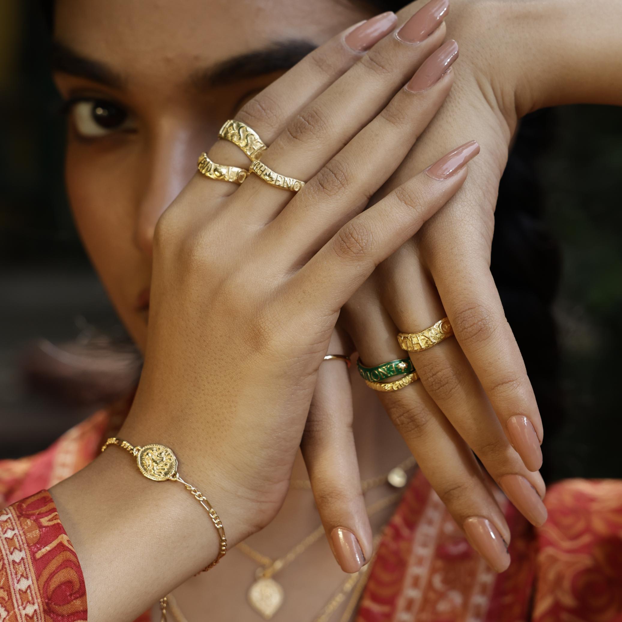Gold vermeil Baby Courage stacking bracelet symbolising strength and bravery, handcrafted by Loft & Daughter worn with stacking rings.