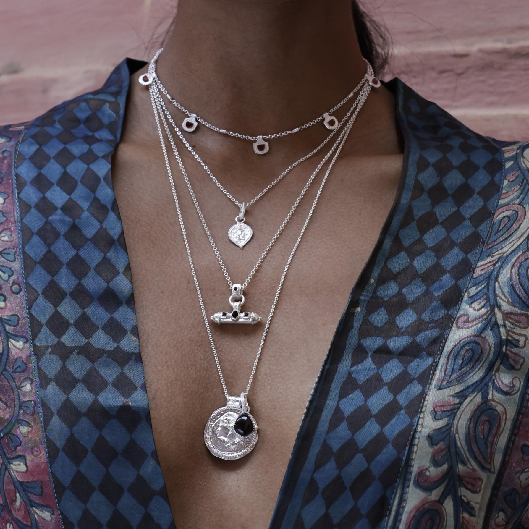 Layering silver pendants by Loft & Daughter featuring Ganesh, Athena and amulet talismans