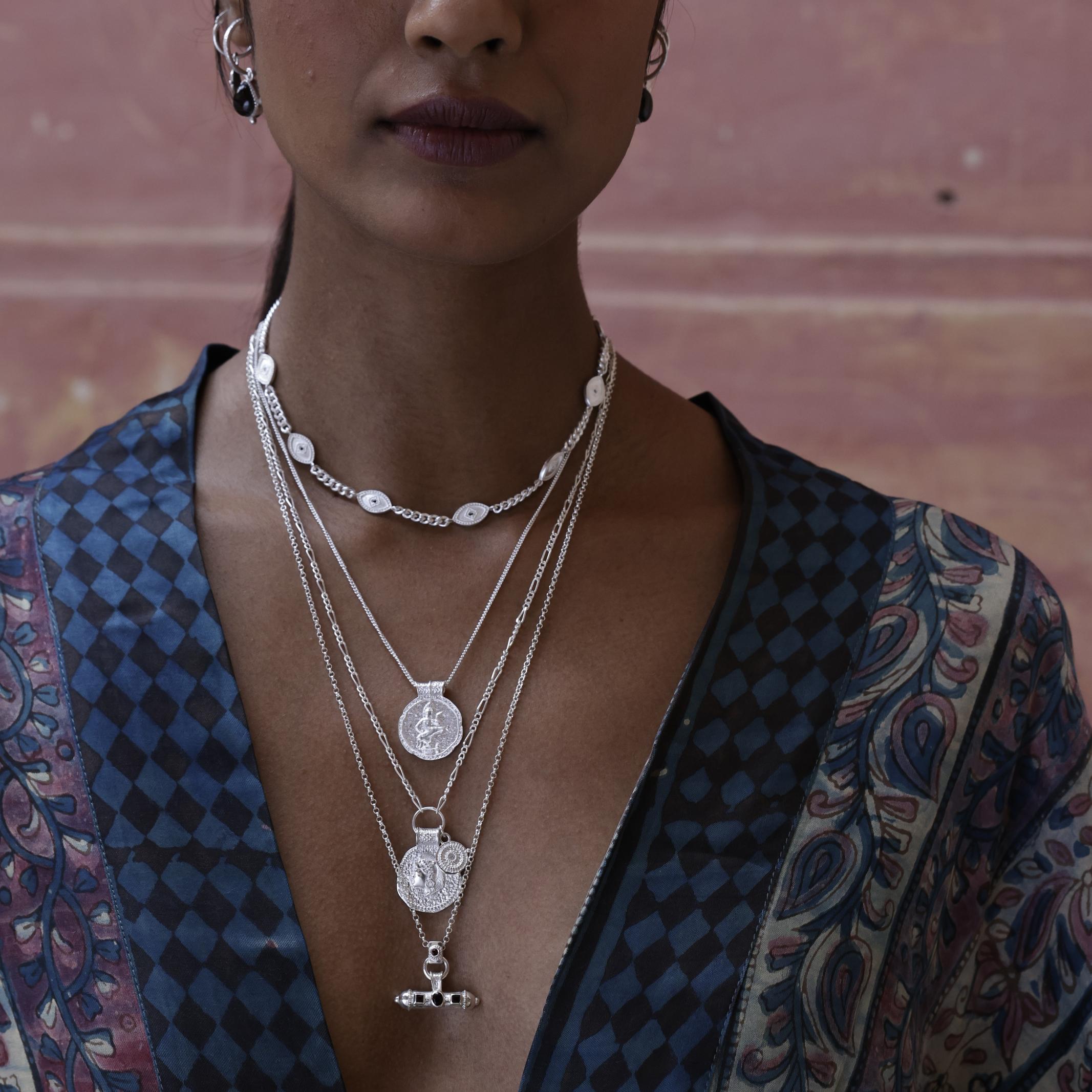 Woman wearing silver layered necklaces with a patterned kimono by Loft & Daughter