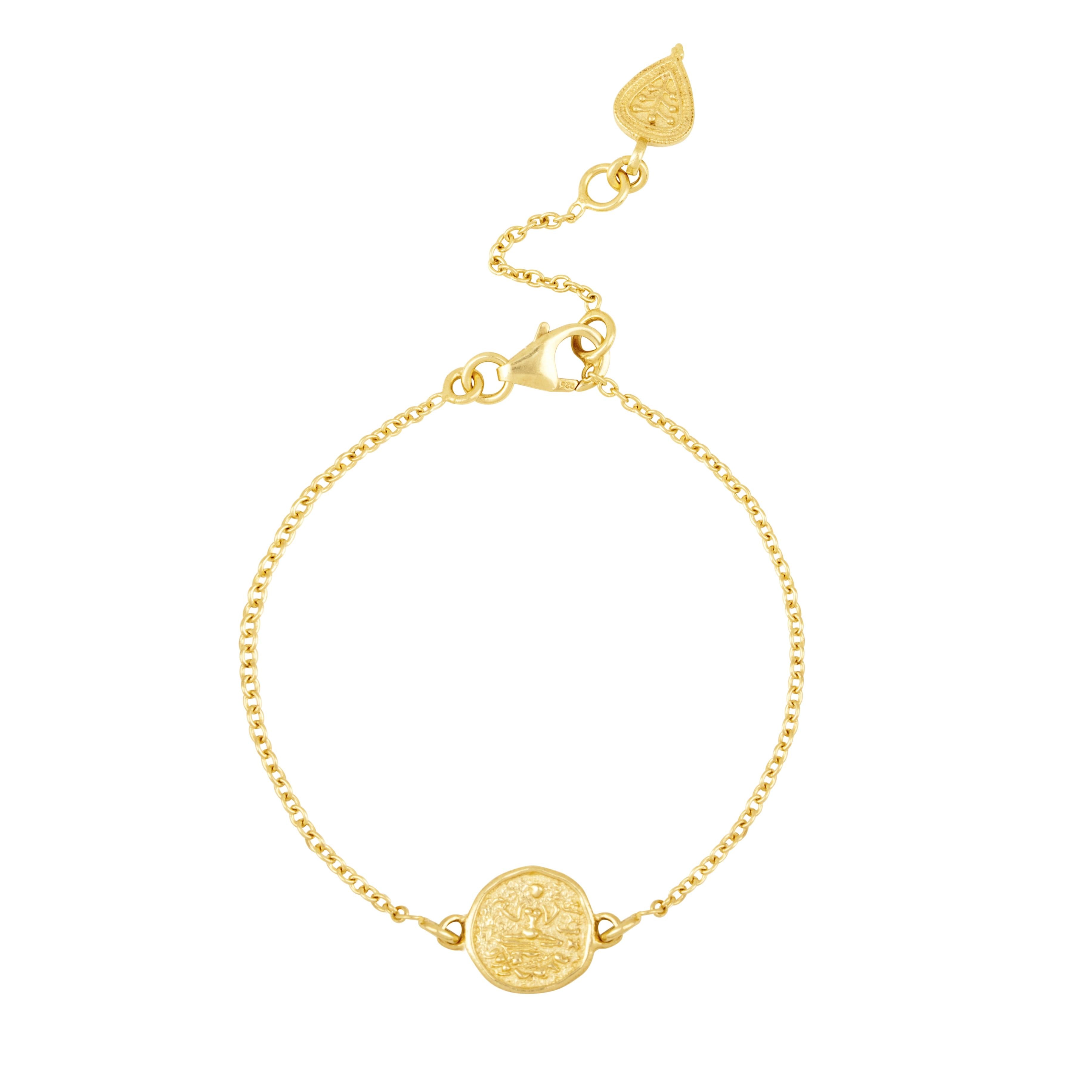 Delicate gold bracelet with round Lakshmi coin by Loft & Daughter on white background
