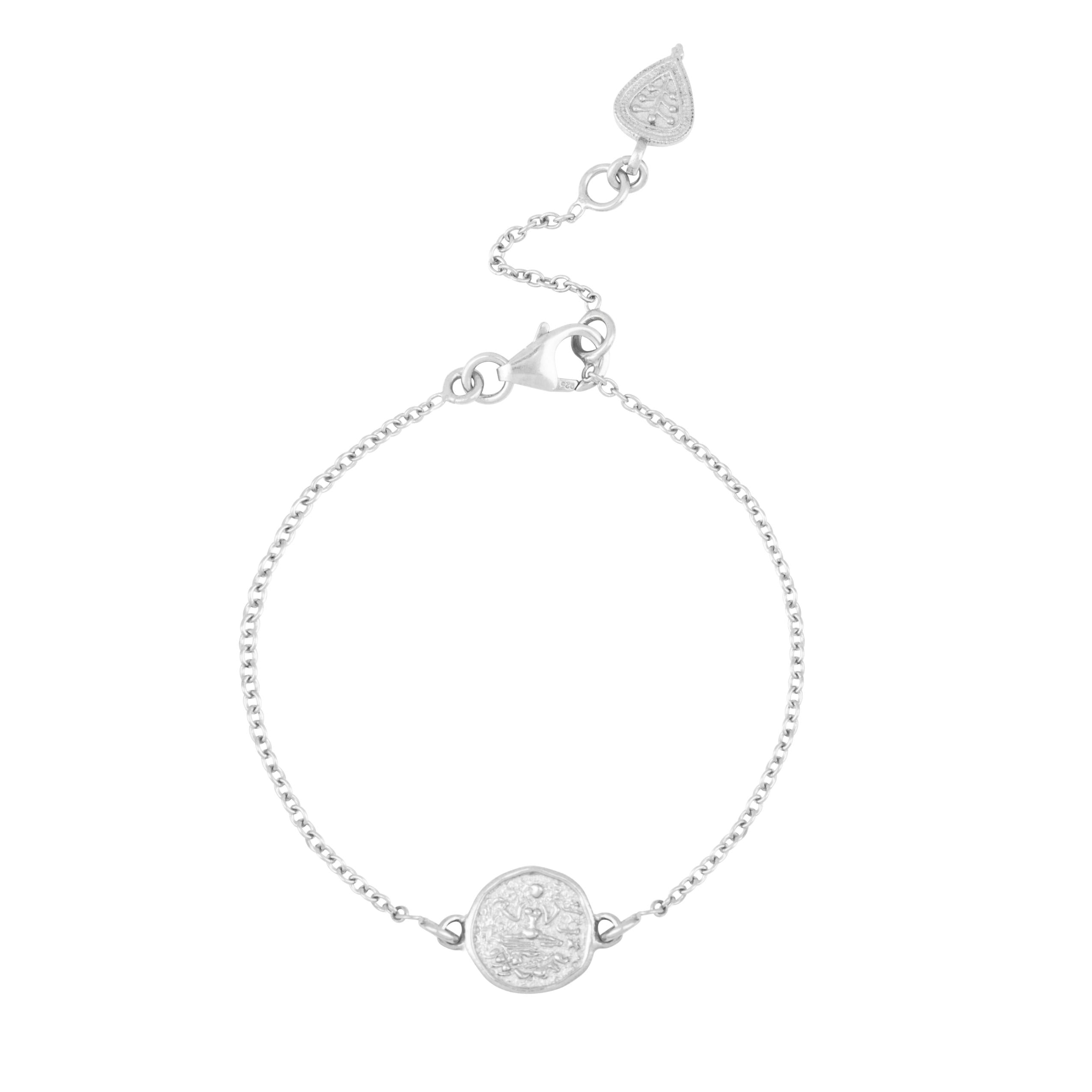 Silver friendship bracelet with delicate coin depicting goddess Lakshmi on white background by Loft & Daughter