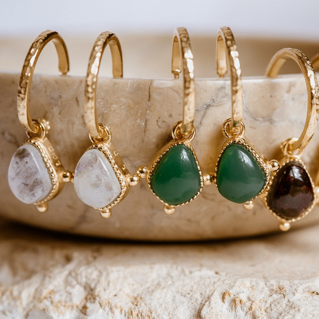 Collection of Soul Stone Hoop Earrings hung on dish