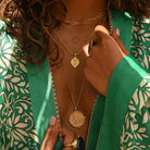 Model wearing green kimono with boho layering pendants by Loft & Daughter