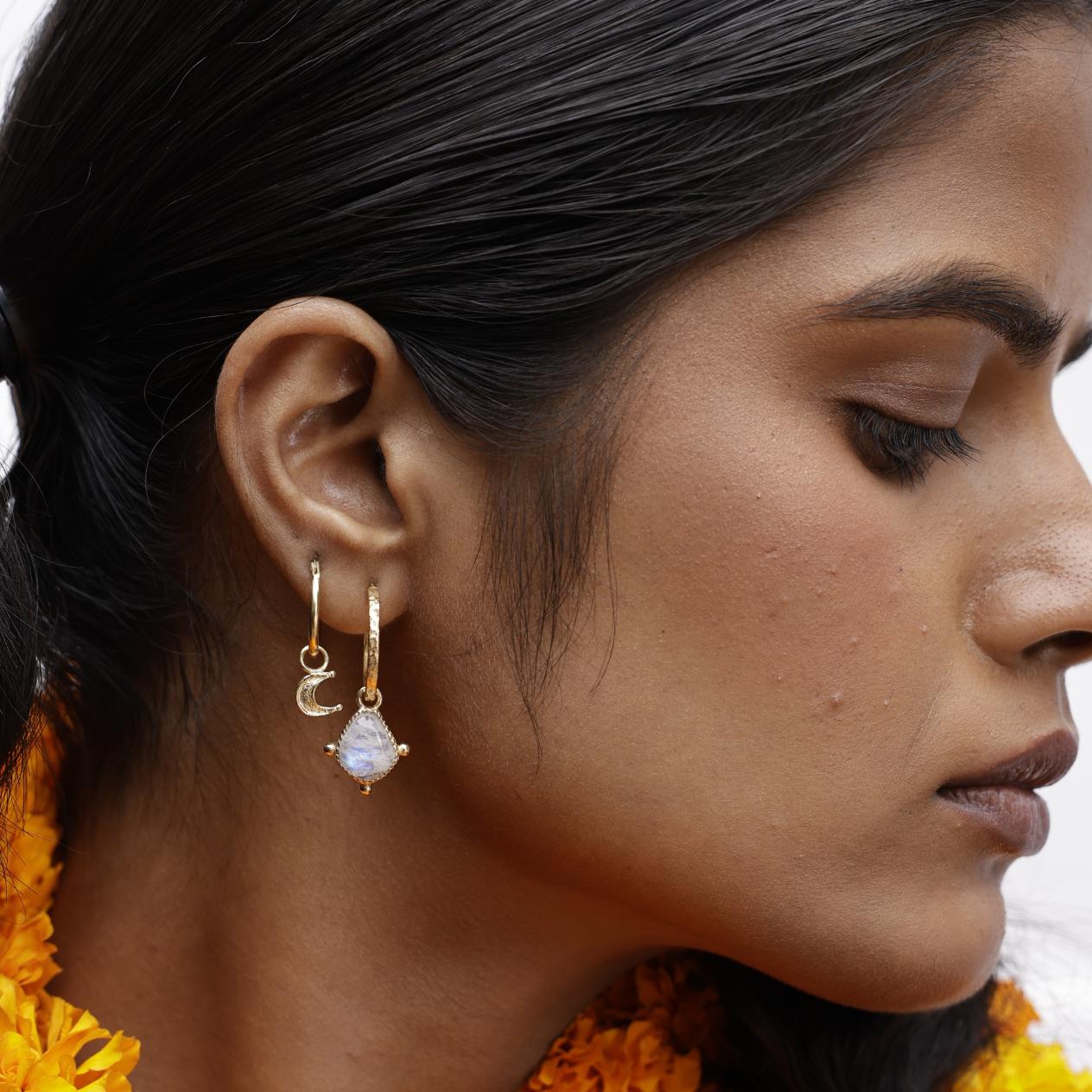 Close up of model wearing moonstone drop hoop with stacking moon hoop