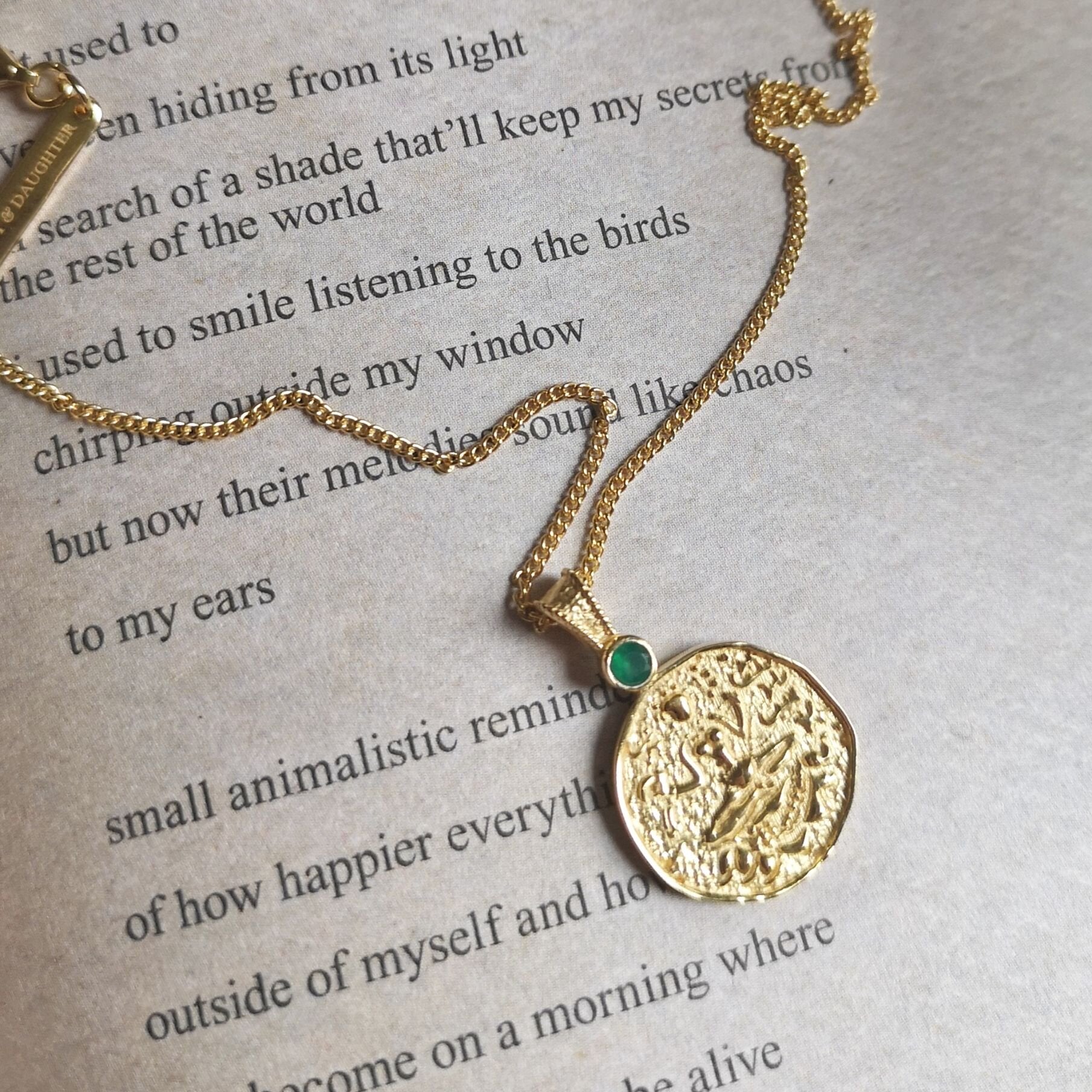 Lakshmi coin pendant placed on book