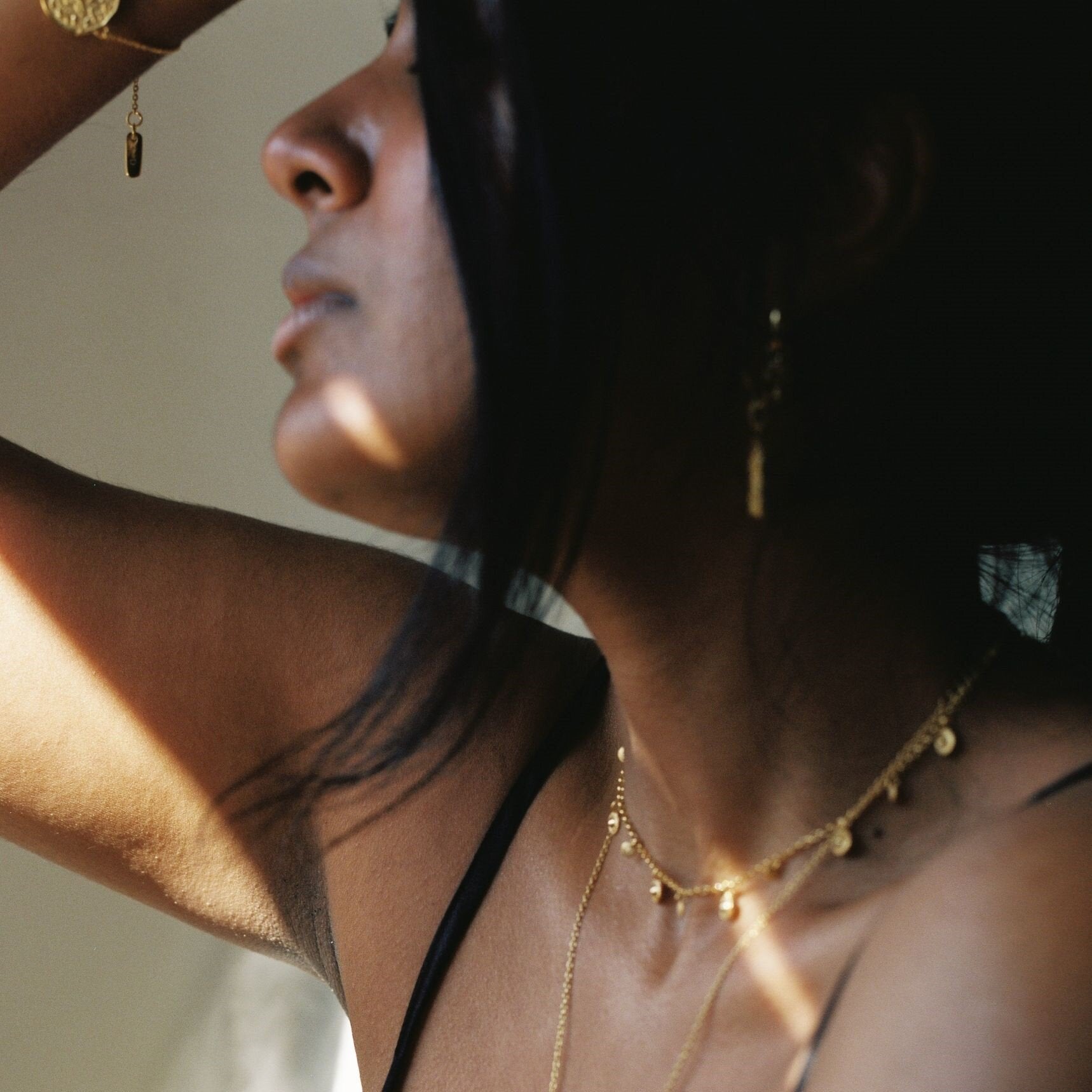 Model wearing delicate mini gold coin choker loft daughter