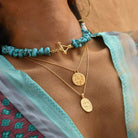 Oval Coin Pendant with Hindu Goddess Durga layered with other gold pendants by Loft & Daughter