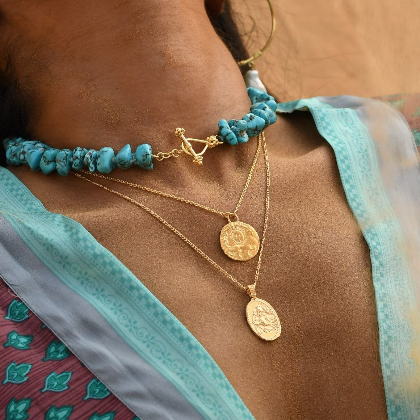 Oval Coin Pendant with Hindu Goddess Durga layered with other gold pendants by Loft & Daughter