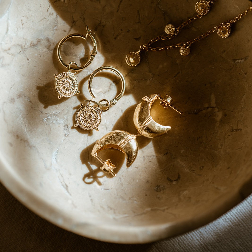 Athena Shield Hoop Earrings displayed with Mini Dome Earrings and matching talismans.