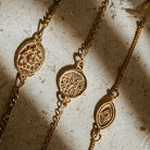 Dainty gold vermeil stacking bracelets featuring oval Durga coin, small Lakshmi charm and delicate evil eye charm by Loft & Daughter