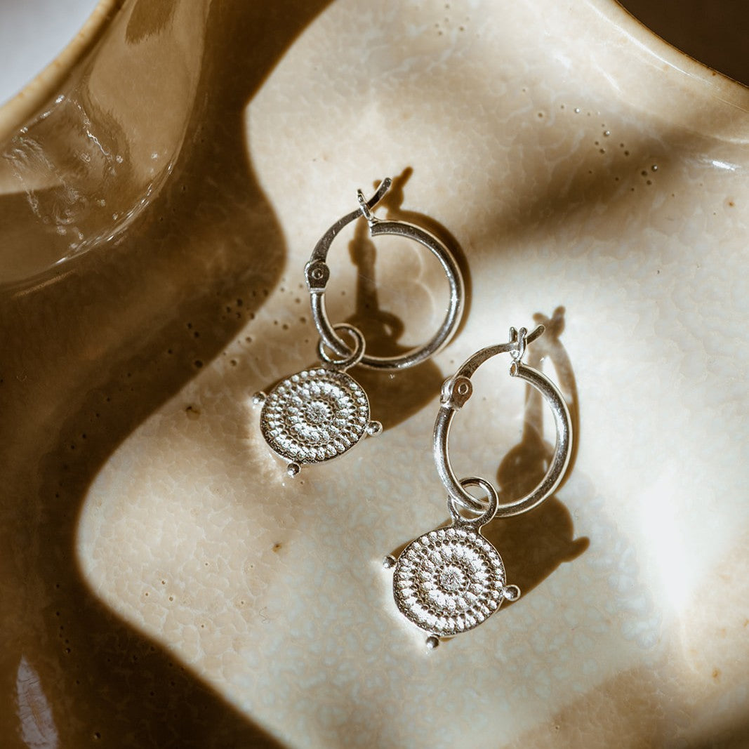 You Got This Athena Shield Hoop Earrings showing intricate detailing and soft silver shine