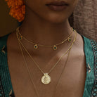 Woman wearing gold necklaces with a green kimono by Loft & Daughter