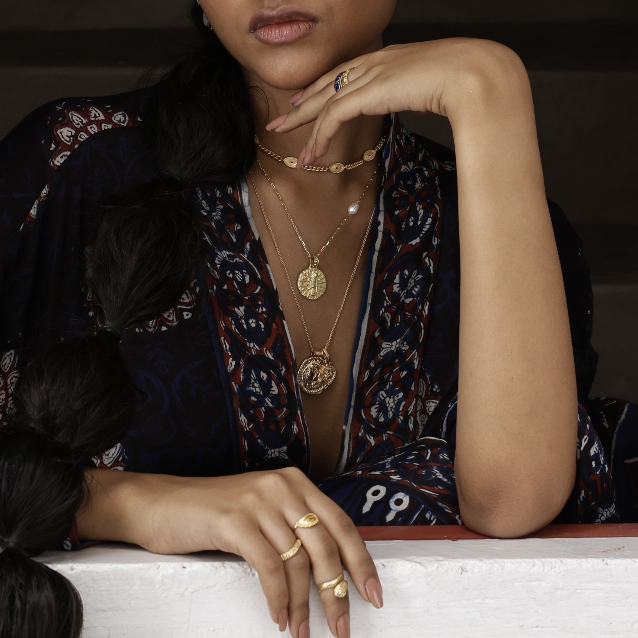 Model wearing gold vermeil Loft & Daughter bohemian layering coin pendants with black kimono
