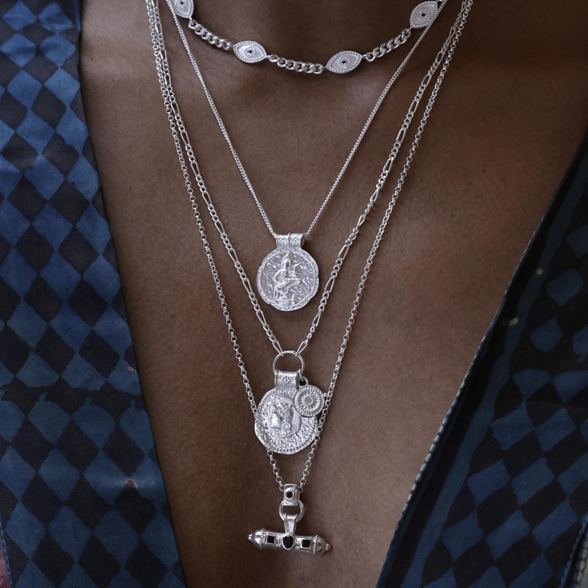 Model wearing You Got This Shield Pendant layered with other silver Loft & Daughter talismans