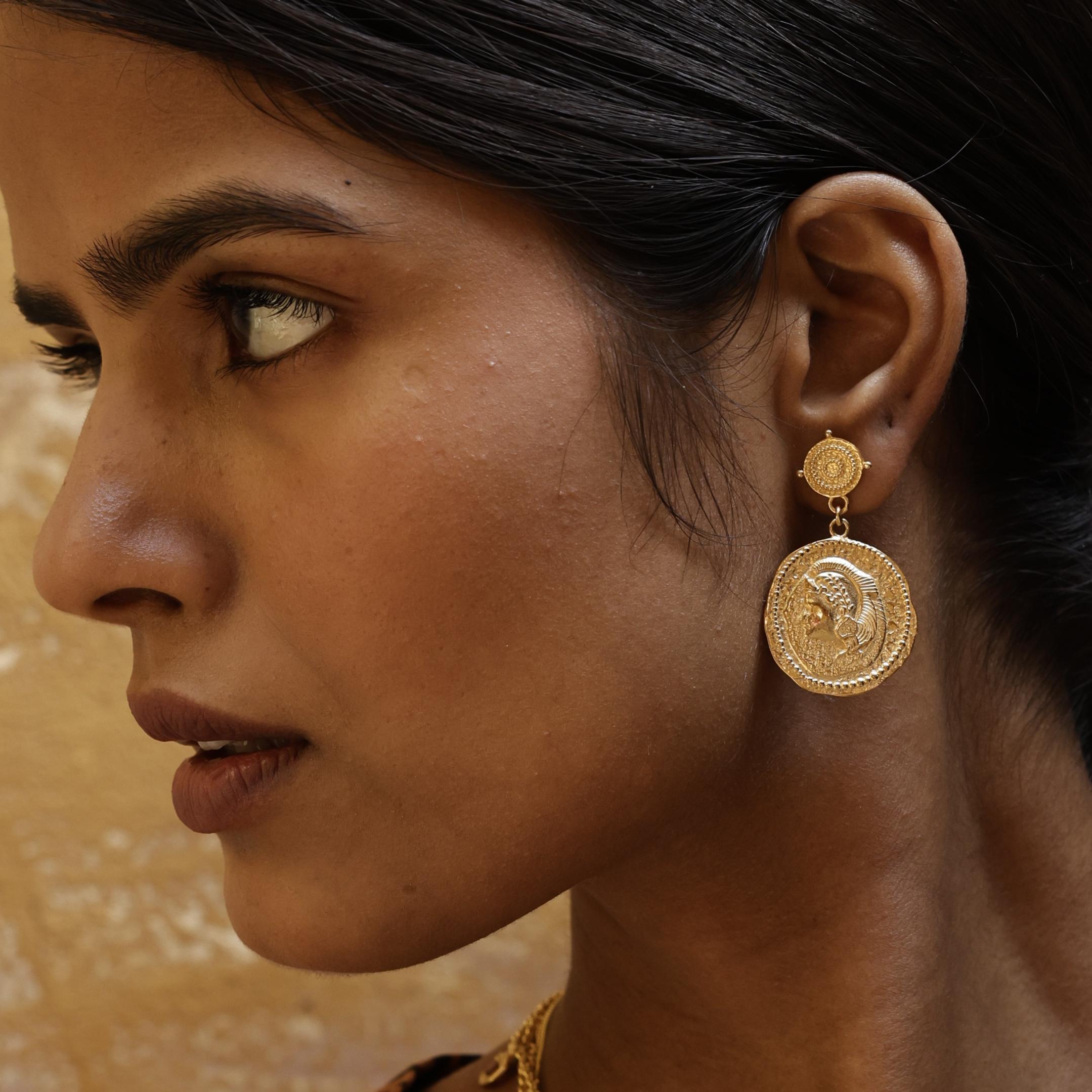 Close-up of You Got This Athena large coin earrings featuring the goddess Athena worn by a model