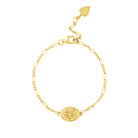 Gold figaro chain bracelet with oval Durga Charm on white background