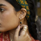 Model close up of red garnet healing stone earring
