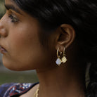 Close up of model wearing boho moonstone hoops and small shield coin hoops