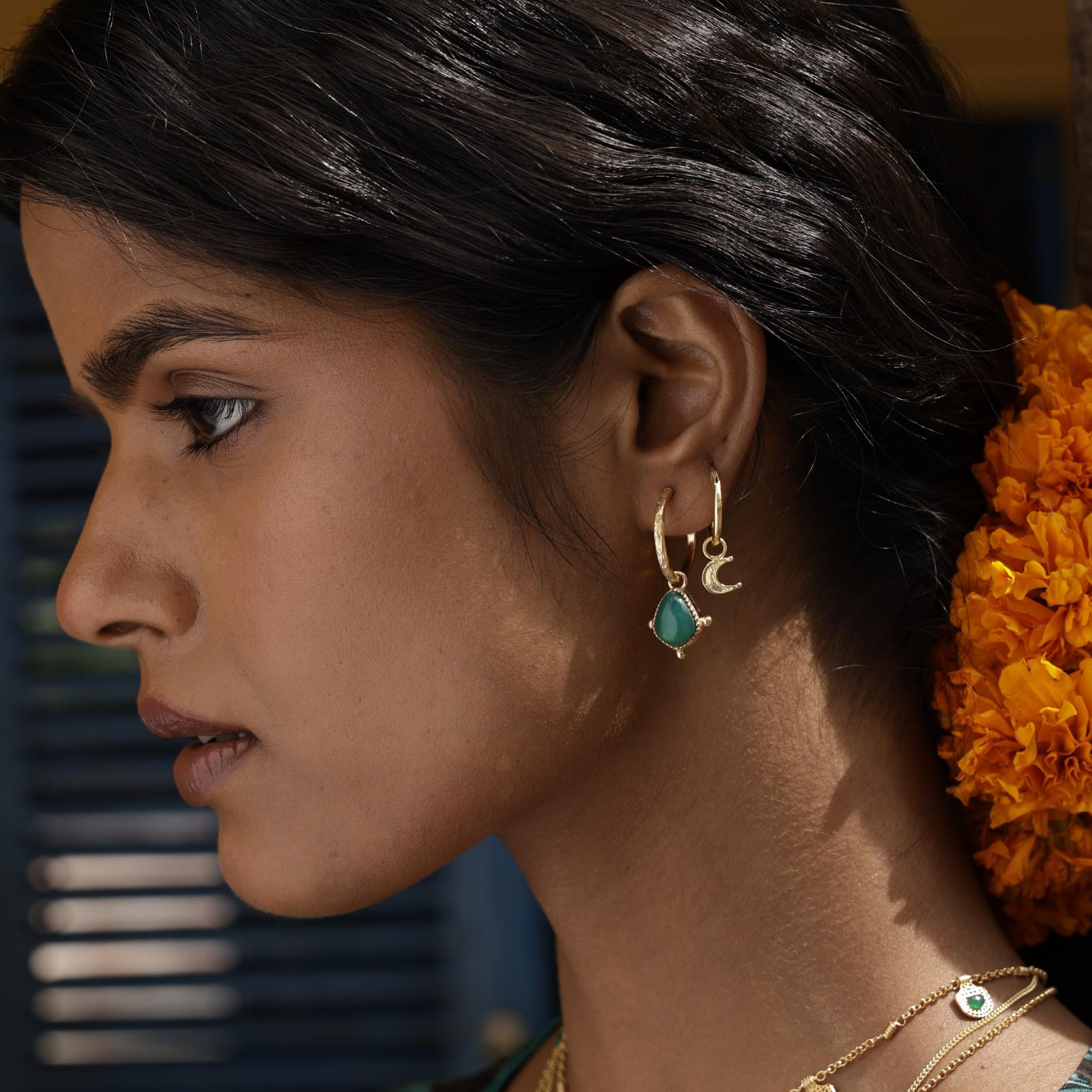 Model wearing tiny moon hoop stacked with gemstone hoop