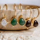 Loft and Daughter soul stone hoops hanging on beige dish