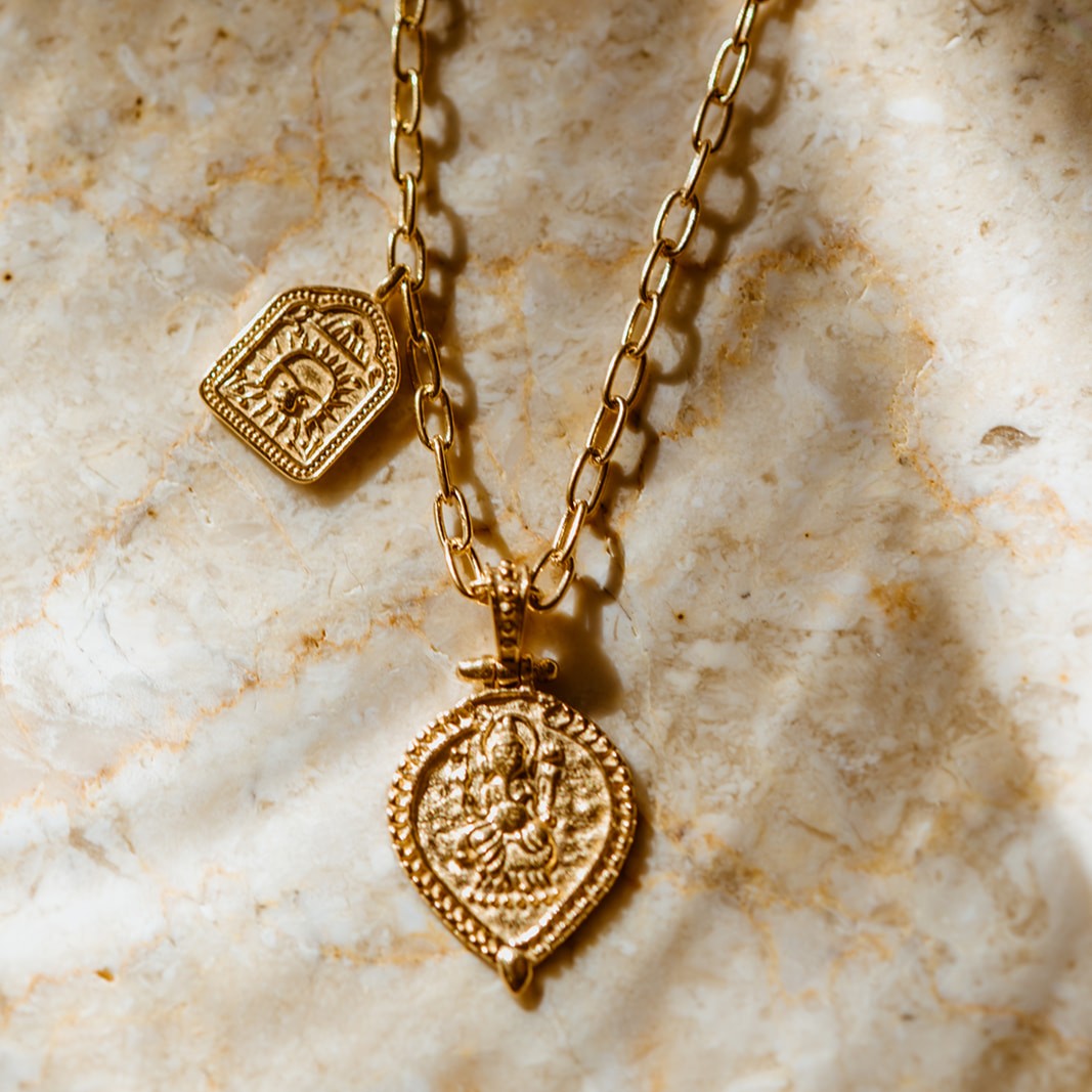 Double charm gold vermeil pendant featuring lord Ganesh and a lion amulet