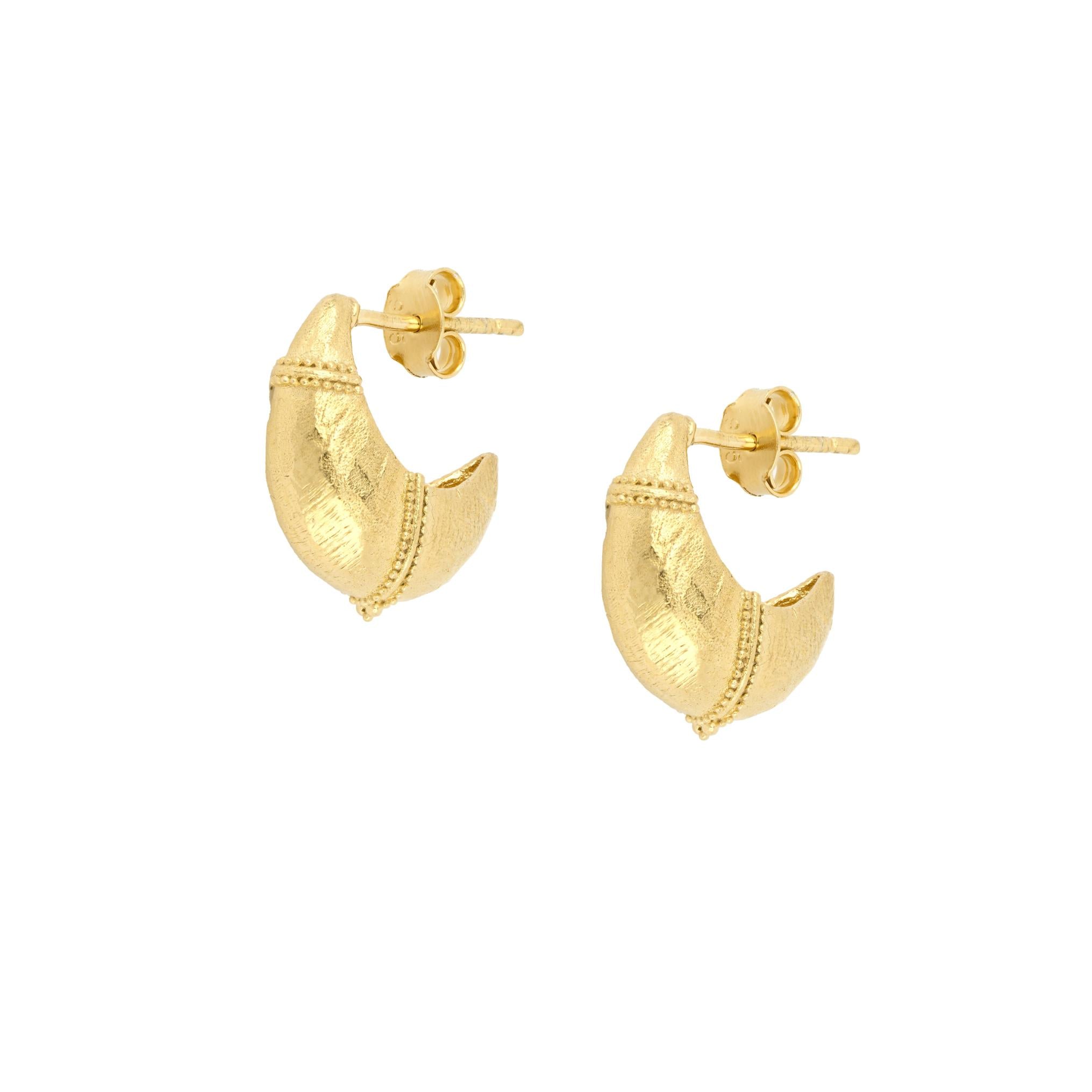 Gold dome cresent hoop earrings on a white background