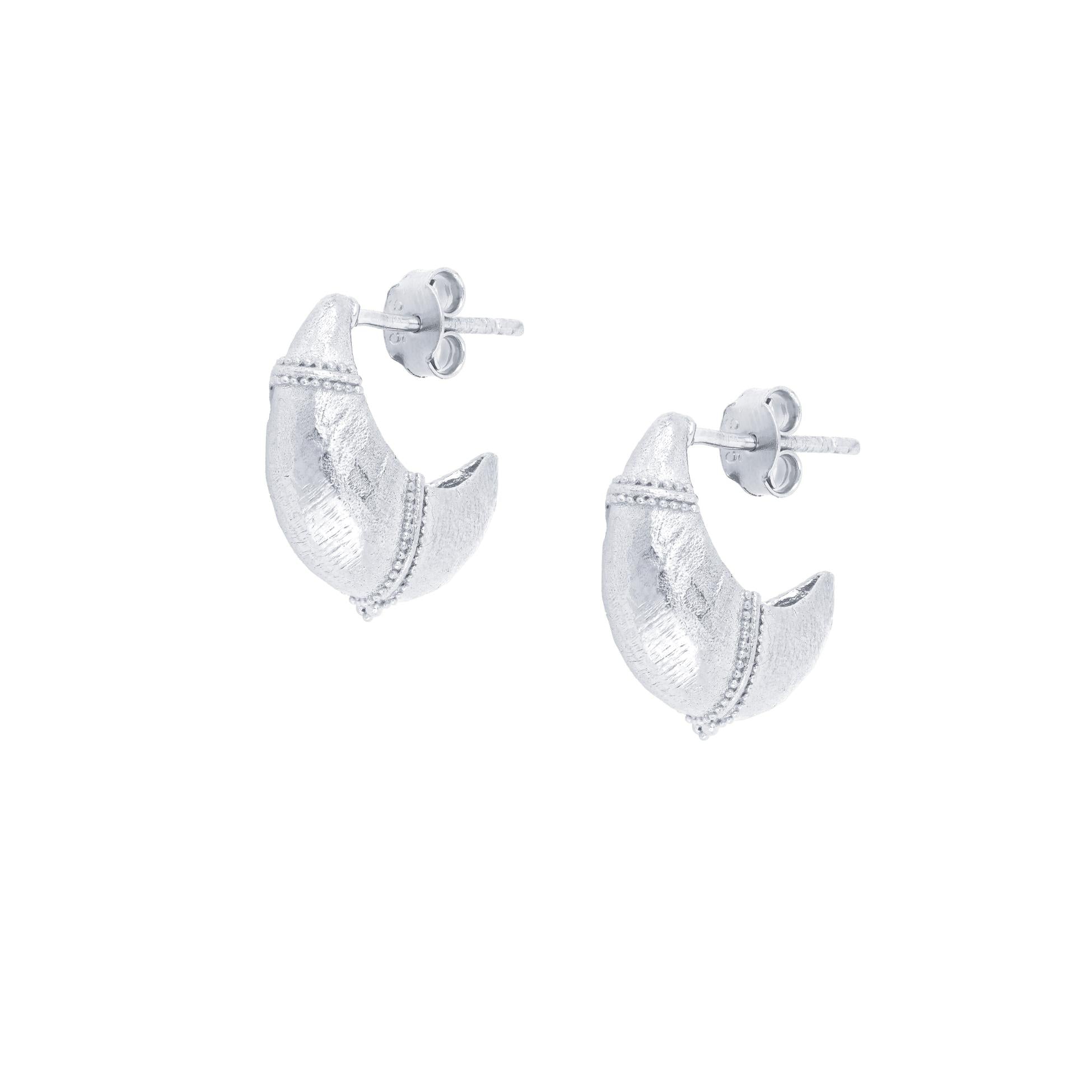 Baby Valora Dome Crescent earrings  with tribal finish on a white background