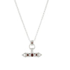 Close-up of the Nivara Amulet Pendant in silver, featuring intricate red garnet gemstones