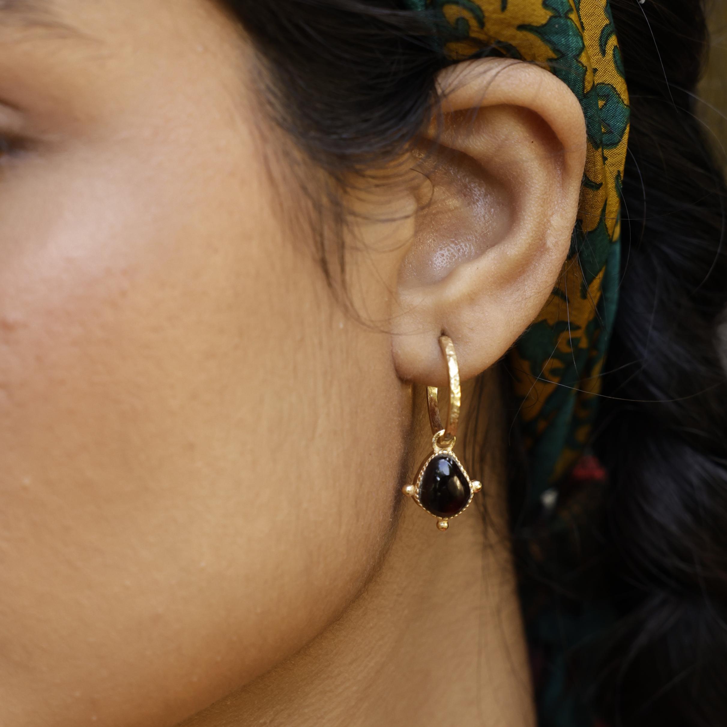 Close up of Red Garnet Soul Stone Hoop on model