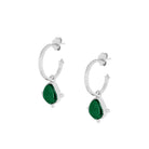 Silver hoop earrings with green stones on a white background