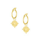Gold hoop earrings in the style of Athena's sheild on a white background