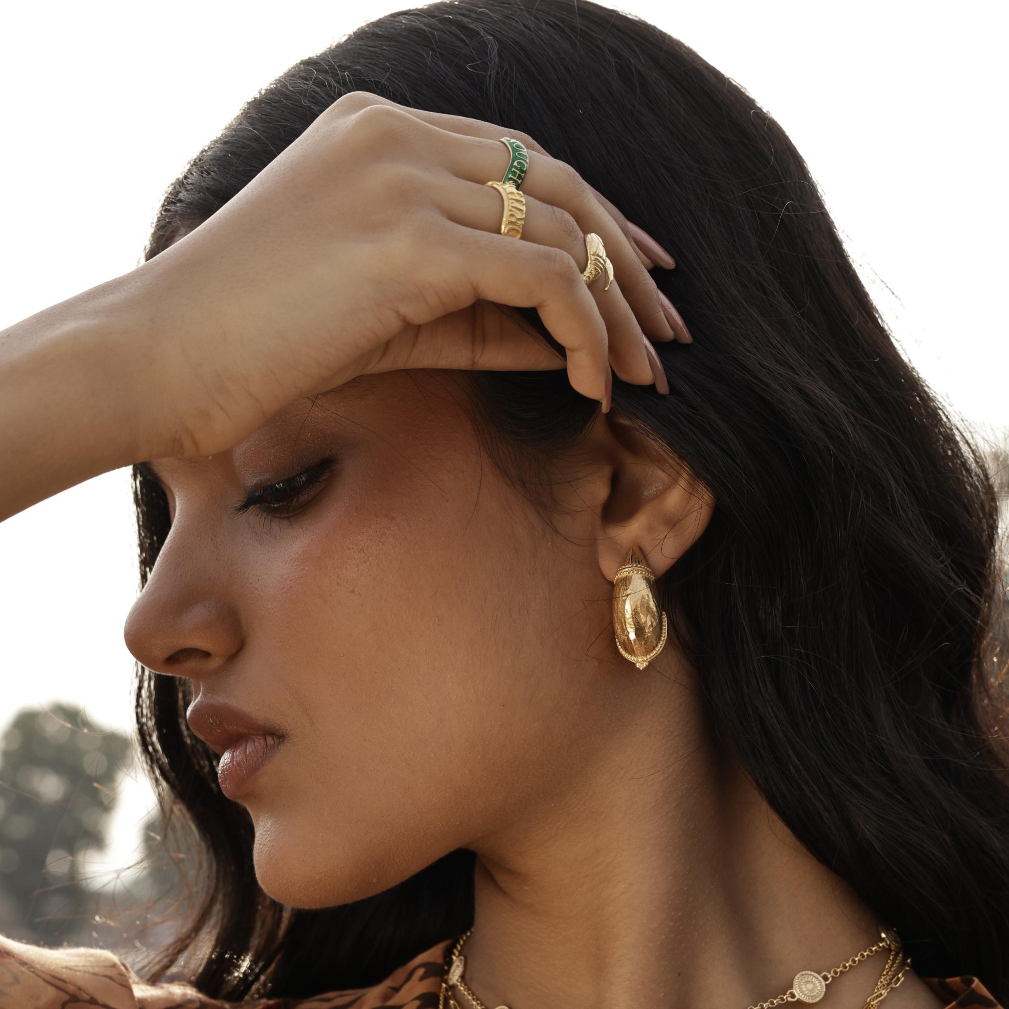 Model wearing chunky domed gold earrings