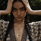 Model wearing bohemian talisman pendants with patterned kimono