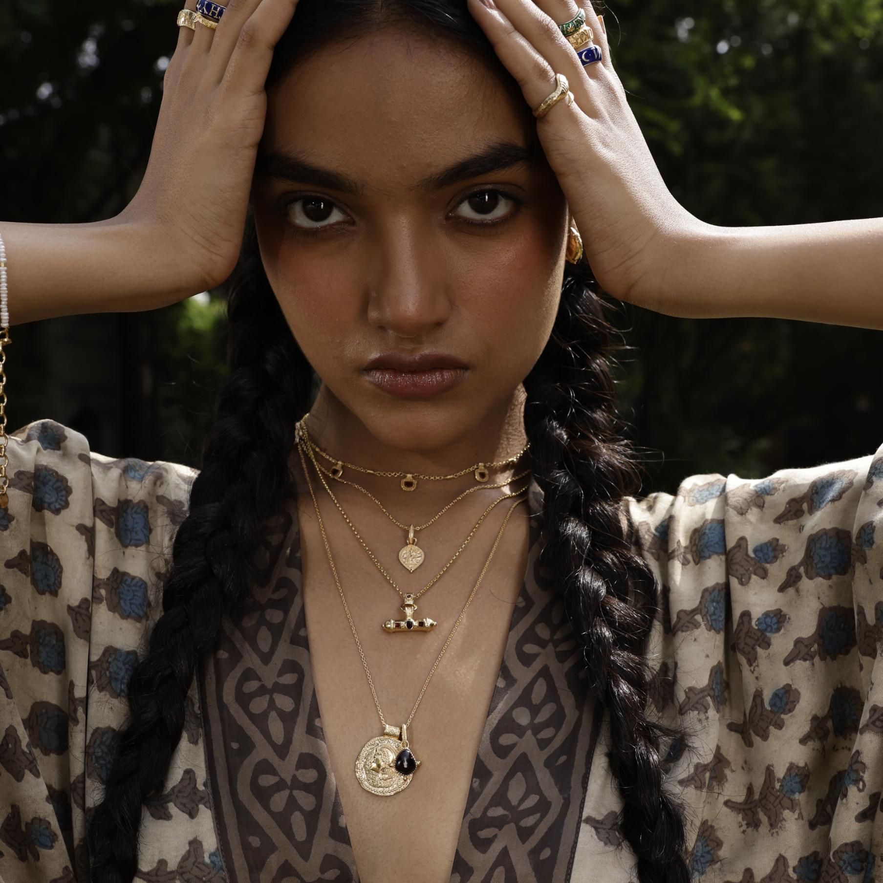 Model wearing bohemian talisman pendants with patterned kimono