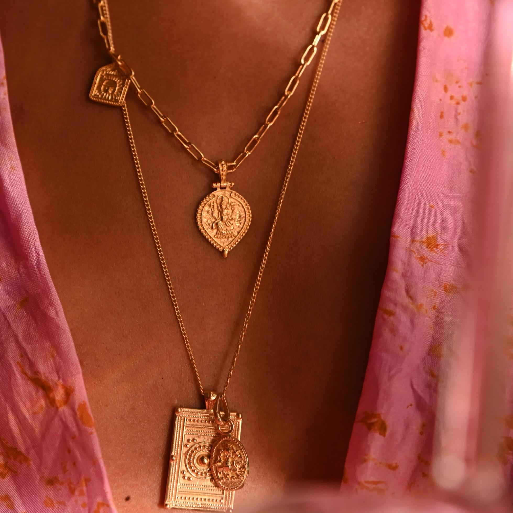 Model wearing new beginnings and kasha pendants with pink kimono