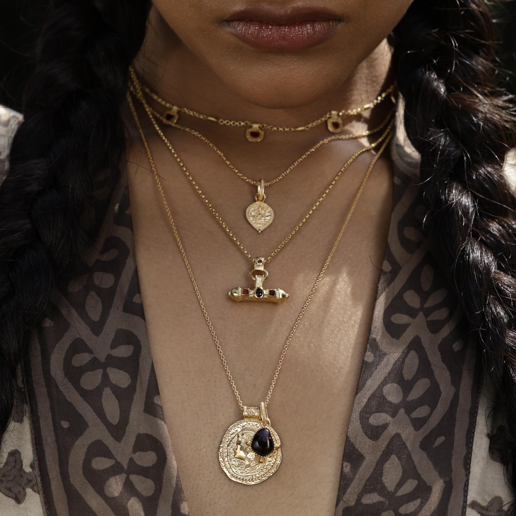 Long gold vermeil pendant inspired by Athena, goddess of courage and clarity worn with other layering amulets