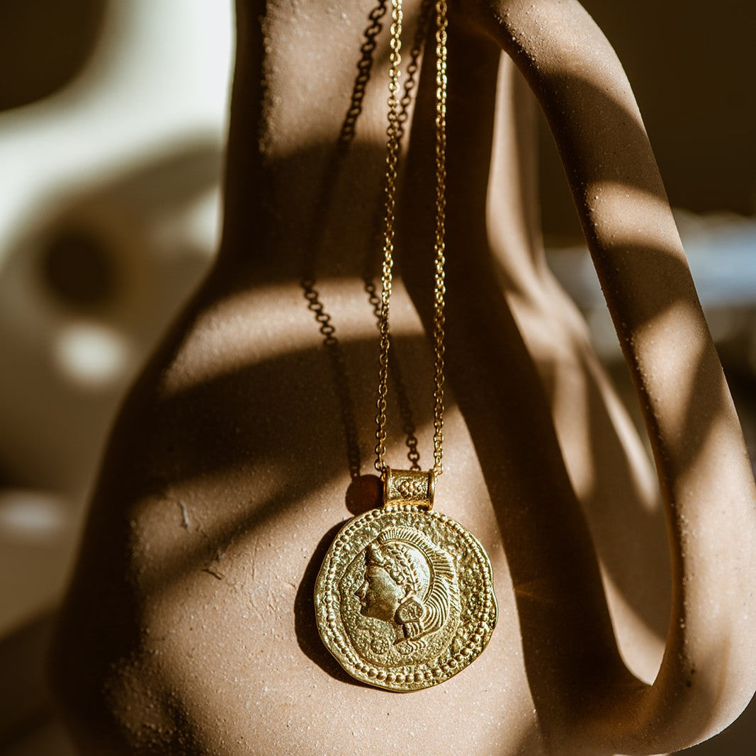 Gold You Got This Pendant by Loft & Daughter hung on a vase