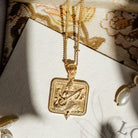 Gold Saraswati pendant necklace on a Loft & Daughter jewellery card with pearl beads