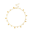 A gold-toned choker necklace featuring multiple small coin-shaped pendants alternating in size and design, displayed against a white background.