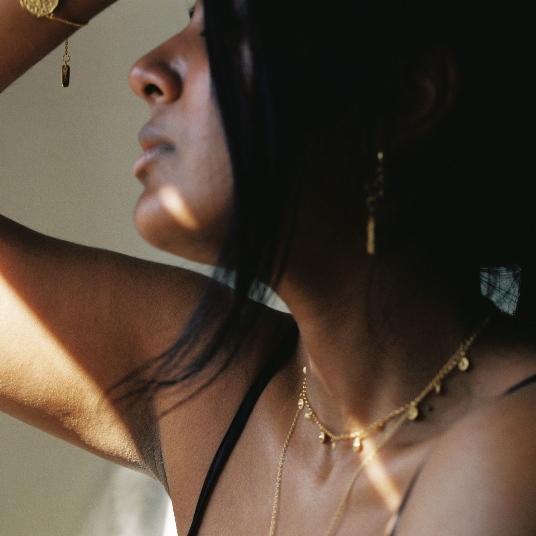 Model wearing delicate mini gold coin choker loft daughter